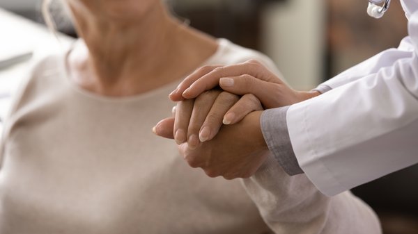 dementia-doctor-comforting-elderly-patient-hands